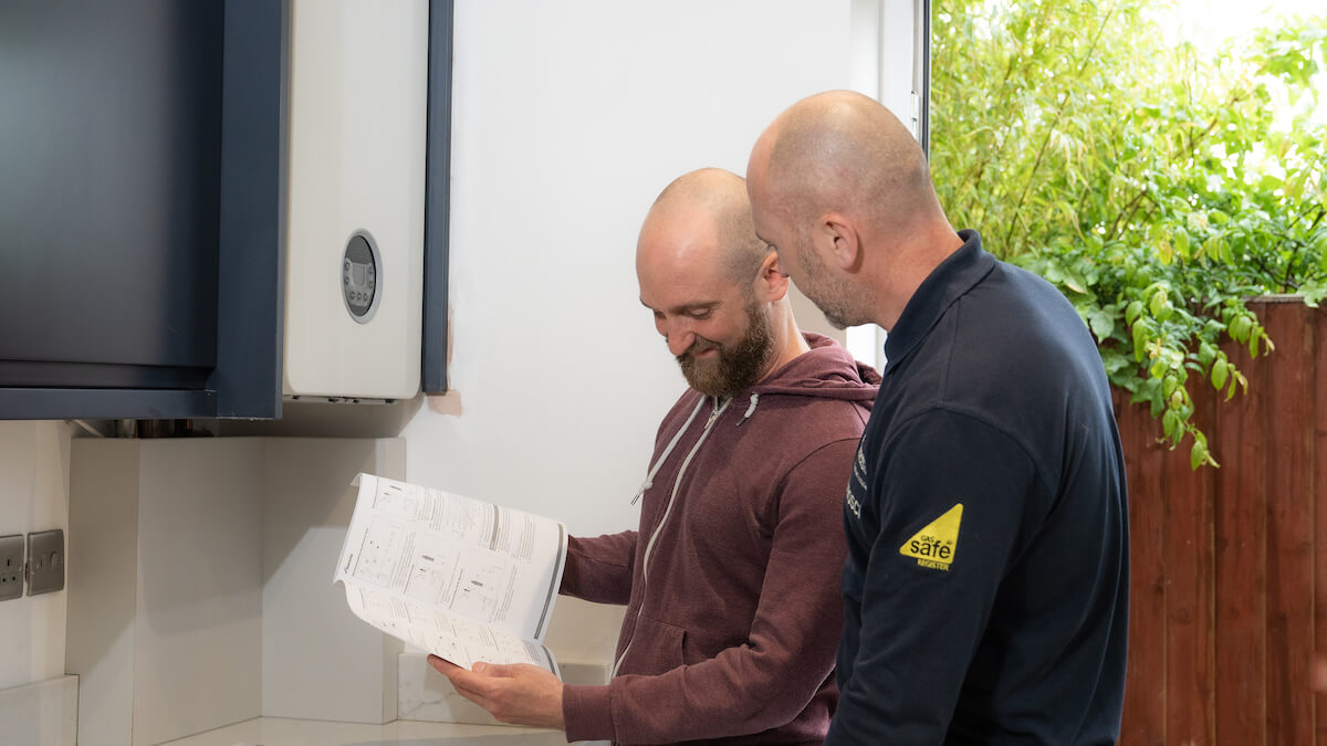 DSC09872 two men talking with paperwork